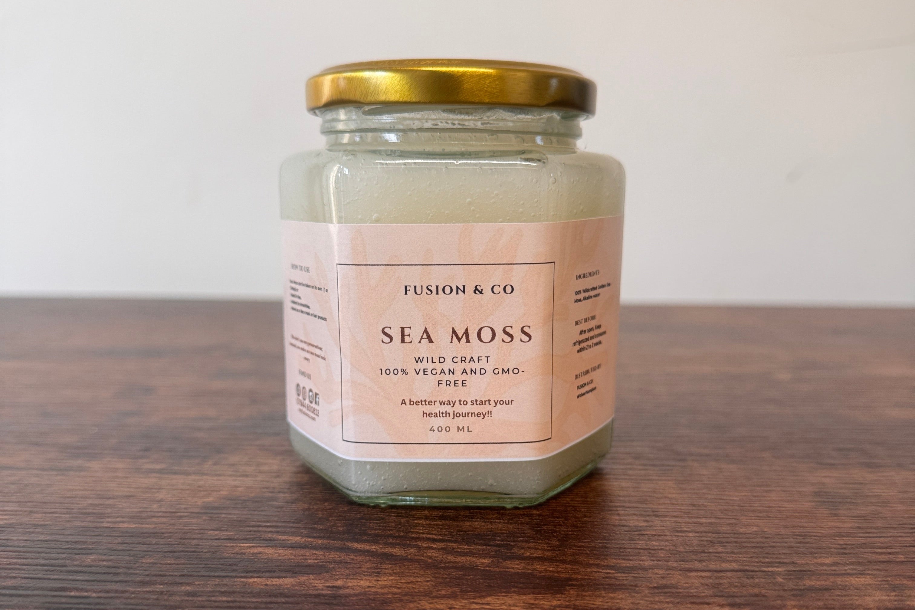 Jar of Sea Moss on a wooden surface with a white background
